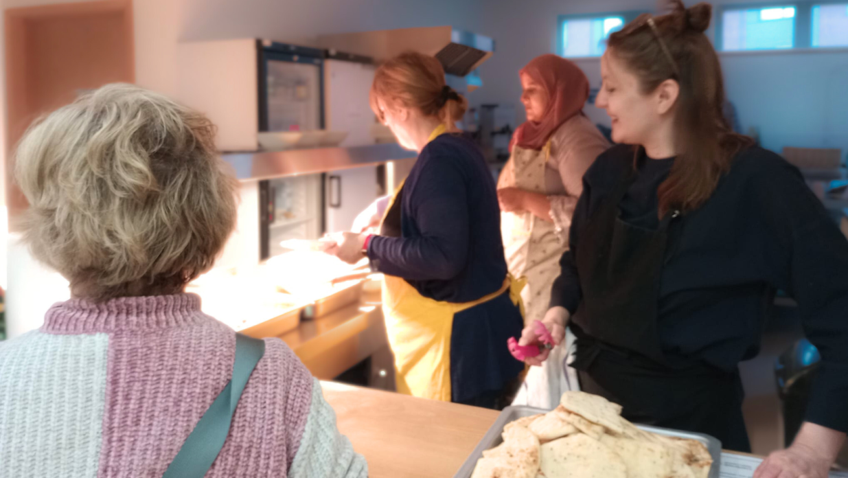 Volunteers serving food at the EX5-Alive community hub.