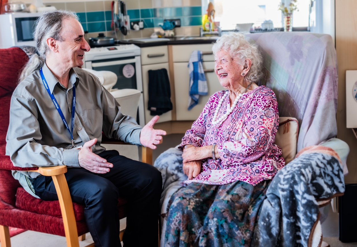 Delcie smiling and chatting with one of our supported housing colleagues.