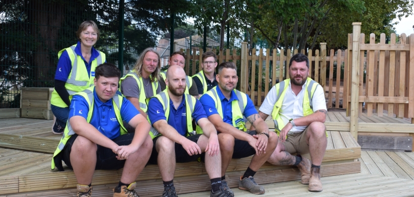 Volunteers sat and stood on the decking they have put in.