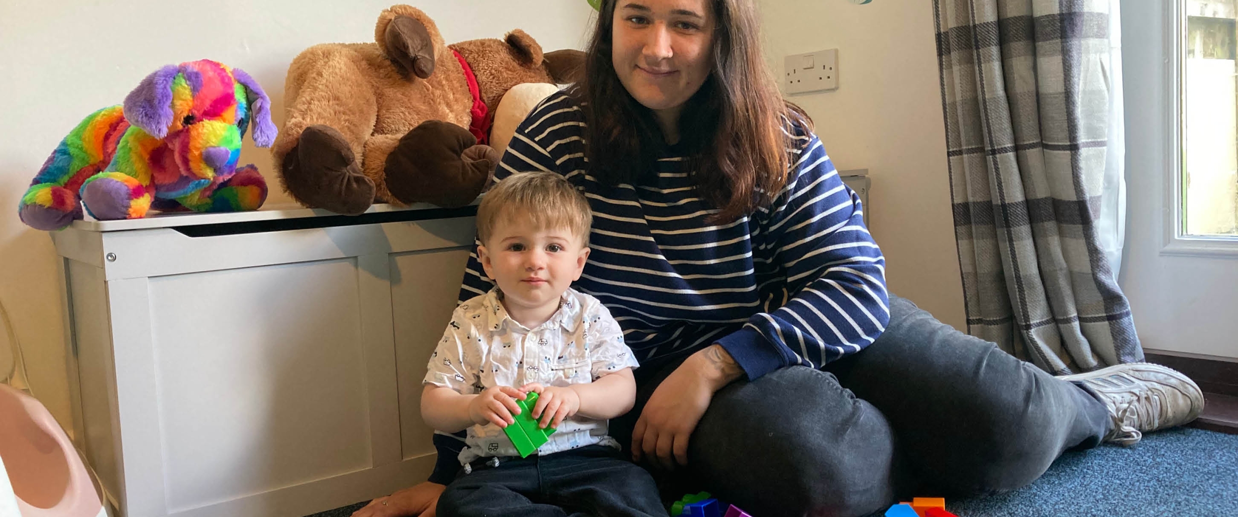 Resident with child playing with toys. 