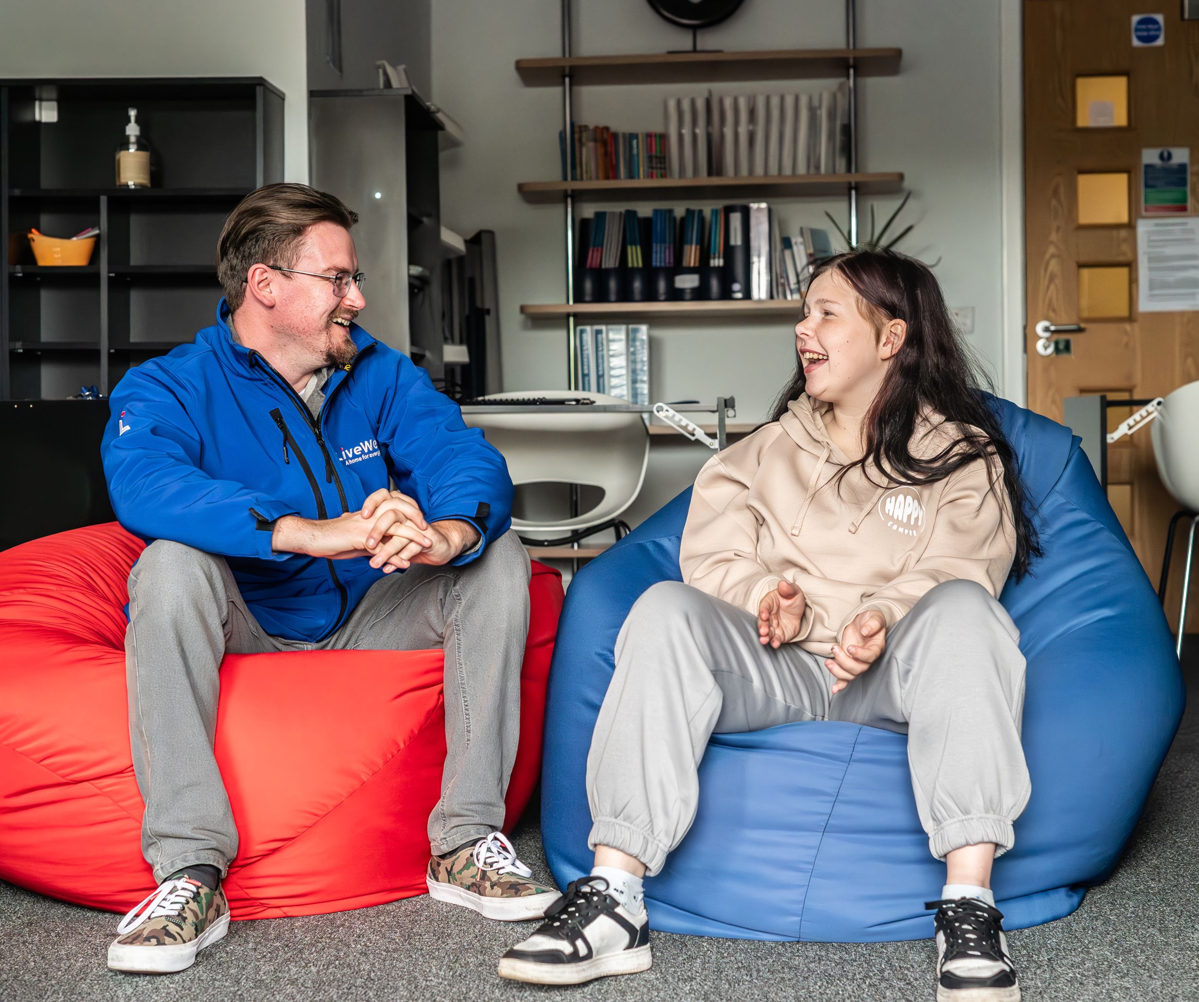 People chatting in Torbay Foyer on bean bags