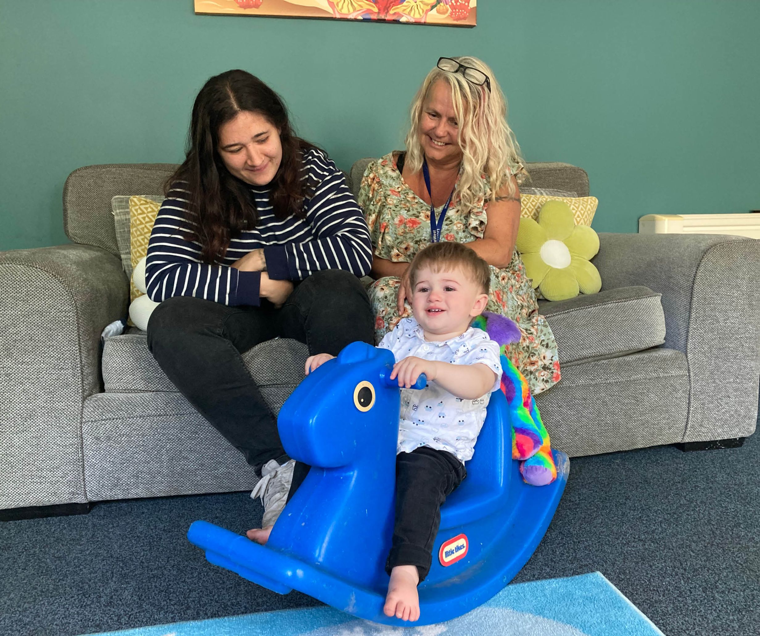 A resident in Carthew House with a child and LiveWest colleague. 