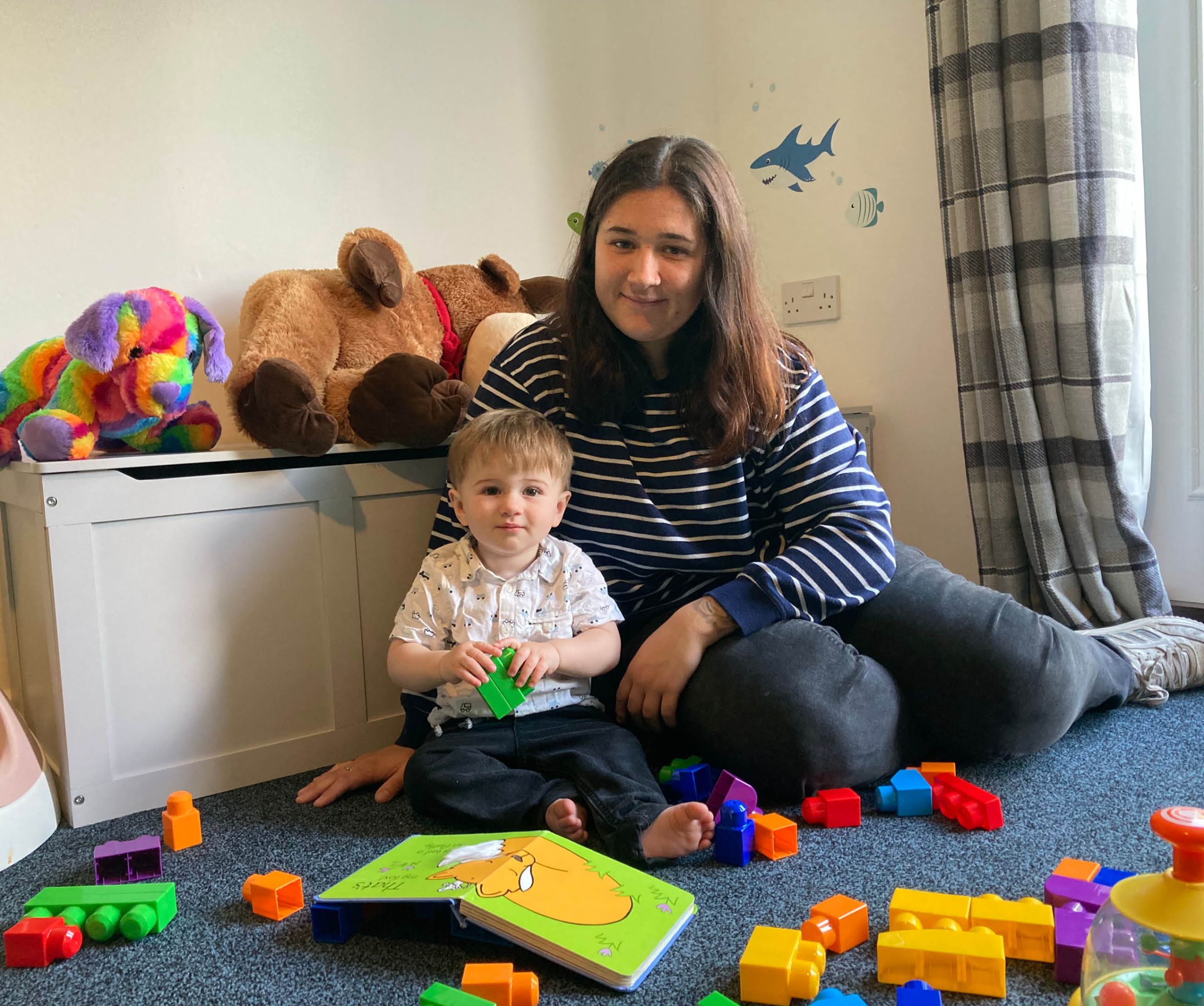 Resident with child playing with toys. 