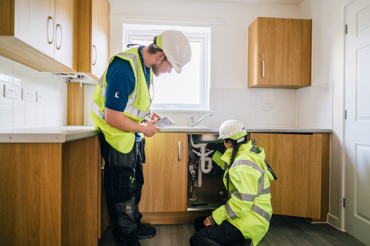 LiveWest colleagues working on a kitchen in a home. 