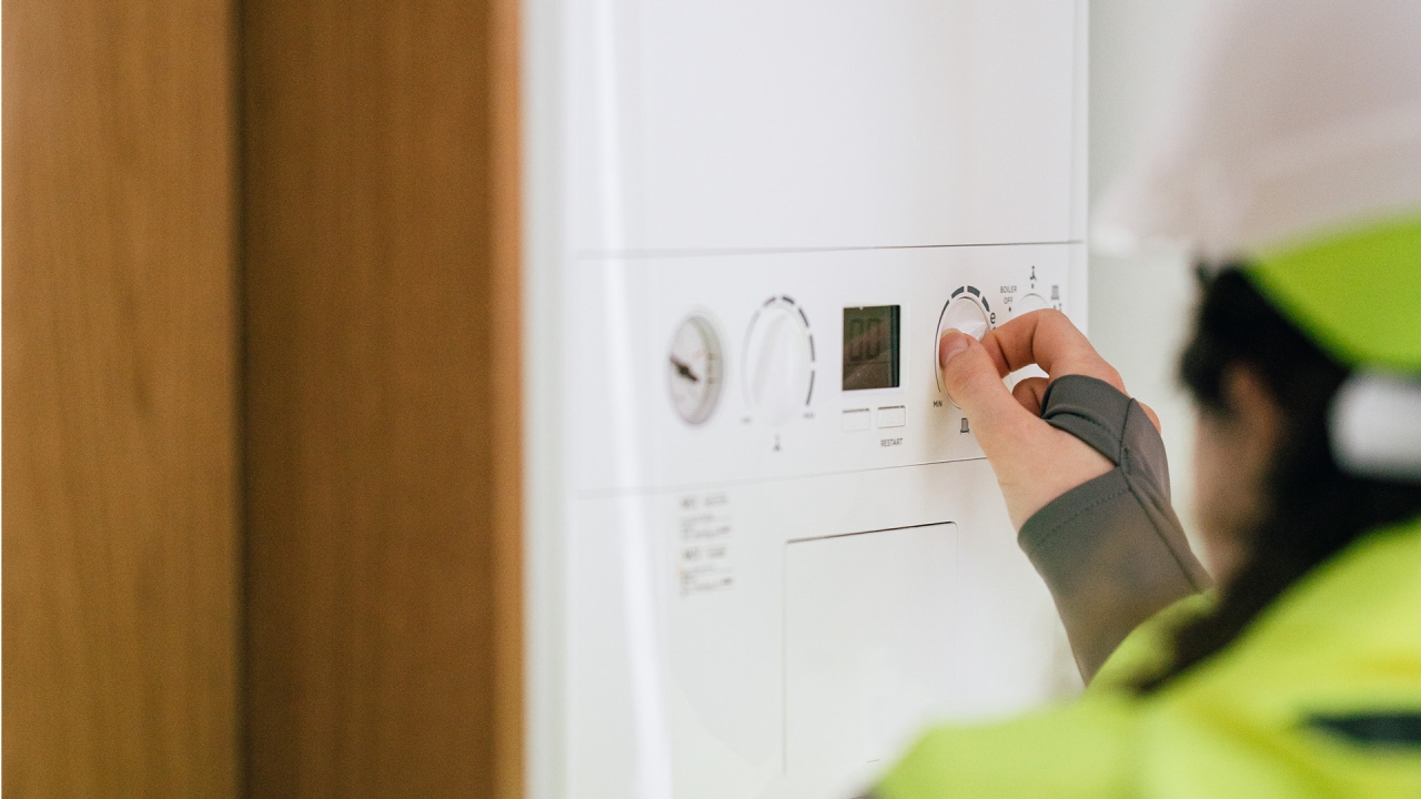 Someone adjusting a boiler. 