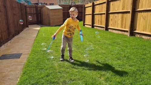 Jaxson playing in his new garden in Hartcliffe