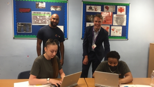 Teacher Jake Mensah and Dan Carter Headteacher at Learning Partnership West School with students and their new laptops LiveWest.