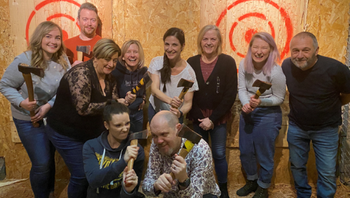 Paul and his friends at an axe throwing class