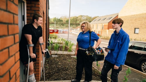 Colleagues chatting with customer at front door