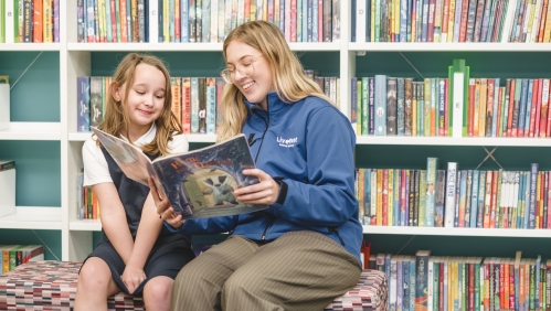 LiveWest colleague reading a book to a child.