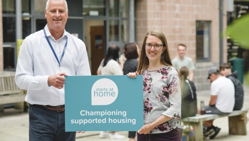 People holding a sign saying 'championing supported housing'. 