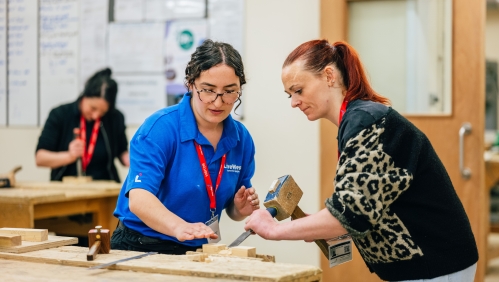 LiveWest colleague helping someone at a trades taster day. 