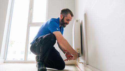 LiveWest colleague doing repairs on a radiator.