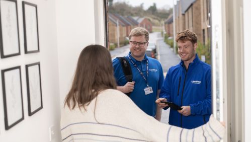 George and Craig chatting to a resident at her front door.