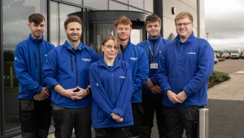 Image of LiveWest apprentices outside a building. 